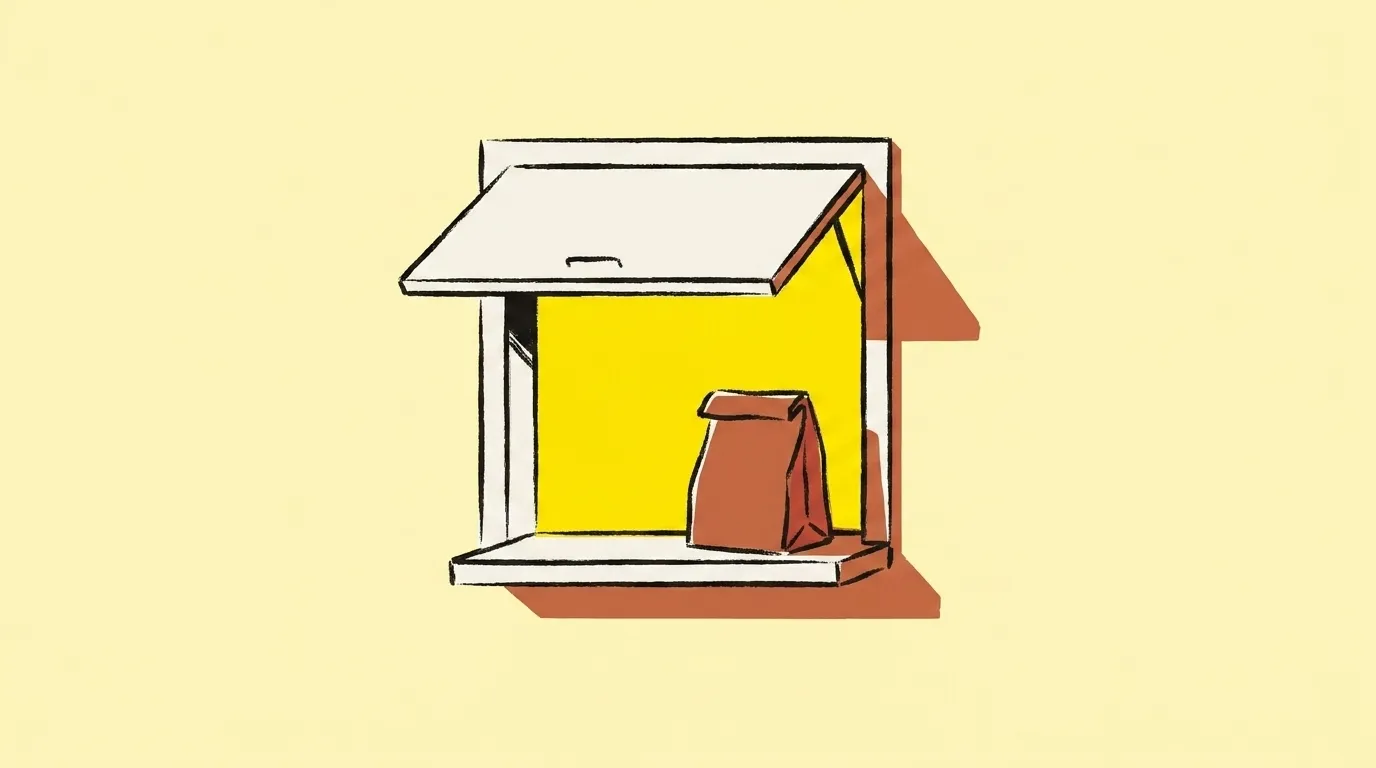 A service window with its shutter propped open and a supply bag on the sill